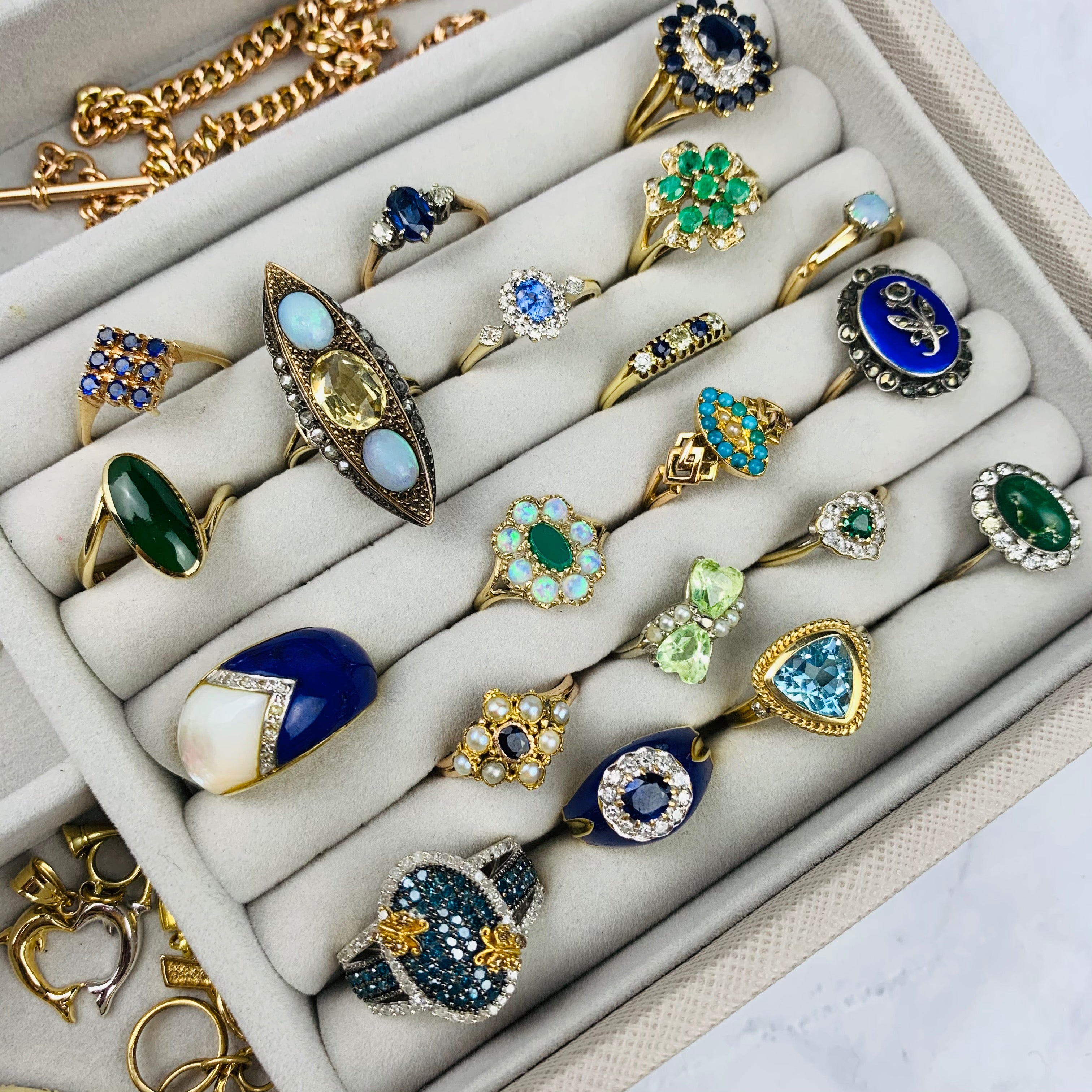 Six rows of vintage and antique gold rings with various gem stones including lapis lazuli, jade, sapphire, opals, citrine, turquoise, sapphire, topaz, an diamonds